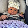 baby, infant, car_seat, hat, bow, blanket, purple, hand, face, eyes, clothing, seatbelt, pacifier, soft, cute, newborn, closeup, portrait, indoors, baby_accessory