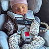 Laneigha is registered to the contest to win money with this photo: newborn, baby, sleeping, car_seat, floral_clothing, pink_hat, bow, safety_harness, infant, cute, child, seatbelt, cozy, portrait, resting, clothing, baby_accessories, indoor, childcare, transportation