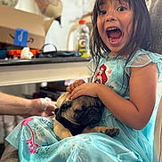 Nacho joined the competition — help win amazing prizes! child, girl, dog, pug, pet, portrait, indoors, kitchen, dress, princess_dress, blue_dress, sitting, 抱抱, smiling, open_mouth, long_hair, brown_hair, couch, family, playful