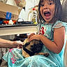 child, girl, dog, pug, pet, portrait, indoors, kitchen, dress, princess_dress, blue_dress, sitting, 抱抱, smiling, open_mouth, long_hair, brown_hair, couch, family, playful