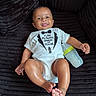 baby, infant, child, smiling, portrait, sitting, onesie, bottle, baby_bottle, black_background, couch, velvet, indoor, closeup, face, hands, feet, happy, casual, photography