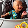 Silas joined the competition — help win amazing prizes! baby, child, infant, smiling, happy, high_chair, sitting, face, portrait, indoor, window, sunlight, toy, rattle, lion_toy, colorful, clothing, safety_harness, playtime, home