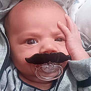 Ivan is registered to the contest to win money with this photo: baby, infant, pacifier, mustache, hand, face, clothing, hoodie, expression, portrait, cute, indoor, skin, head, eyes, newborn, child, babywear, funny, closeup