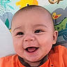 animal_illustrations, baby, background, child, closeup, cute, expression, eyes, face, happy, head, indoors, infant, mouth, orange_clothing, person, play_mat, portrait, skin, smiling
