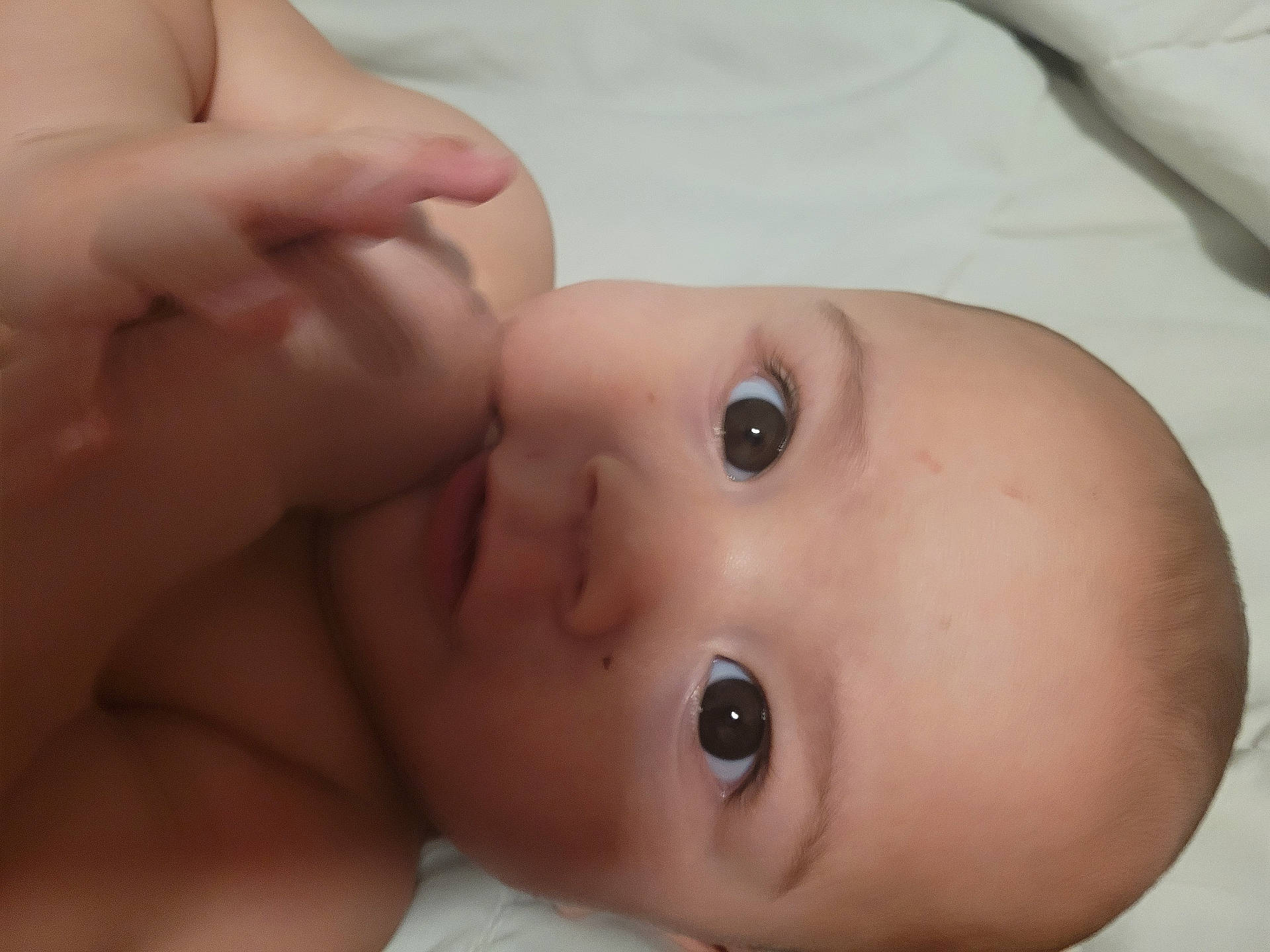 Ivan joined the competition — help win amazing prizes! baby, child, closeup, curious, cute, expression, eyes, face, hand, head, human, indoors, infant, lying_down, newborn, portrait, skin, sleeping_area, soft, young