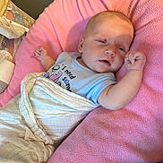 Autumn joined the competition — help win amazing prizes! baby, blanket, pink, cushion, sleepy, infant, onesie, clothing, face, person, resting, soft, indoor, cute, child, wrapped, newborn, lying_down, relaxed, cozy