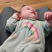 Pam joined the competition — help win amazing prizes! baby, infant, onesie, rainbow, person, clothing, floor, wooden_floor, lap, resting, casual, indoor, cute, child, soft_colors, young, sleepy, hand, face, cozy