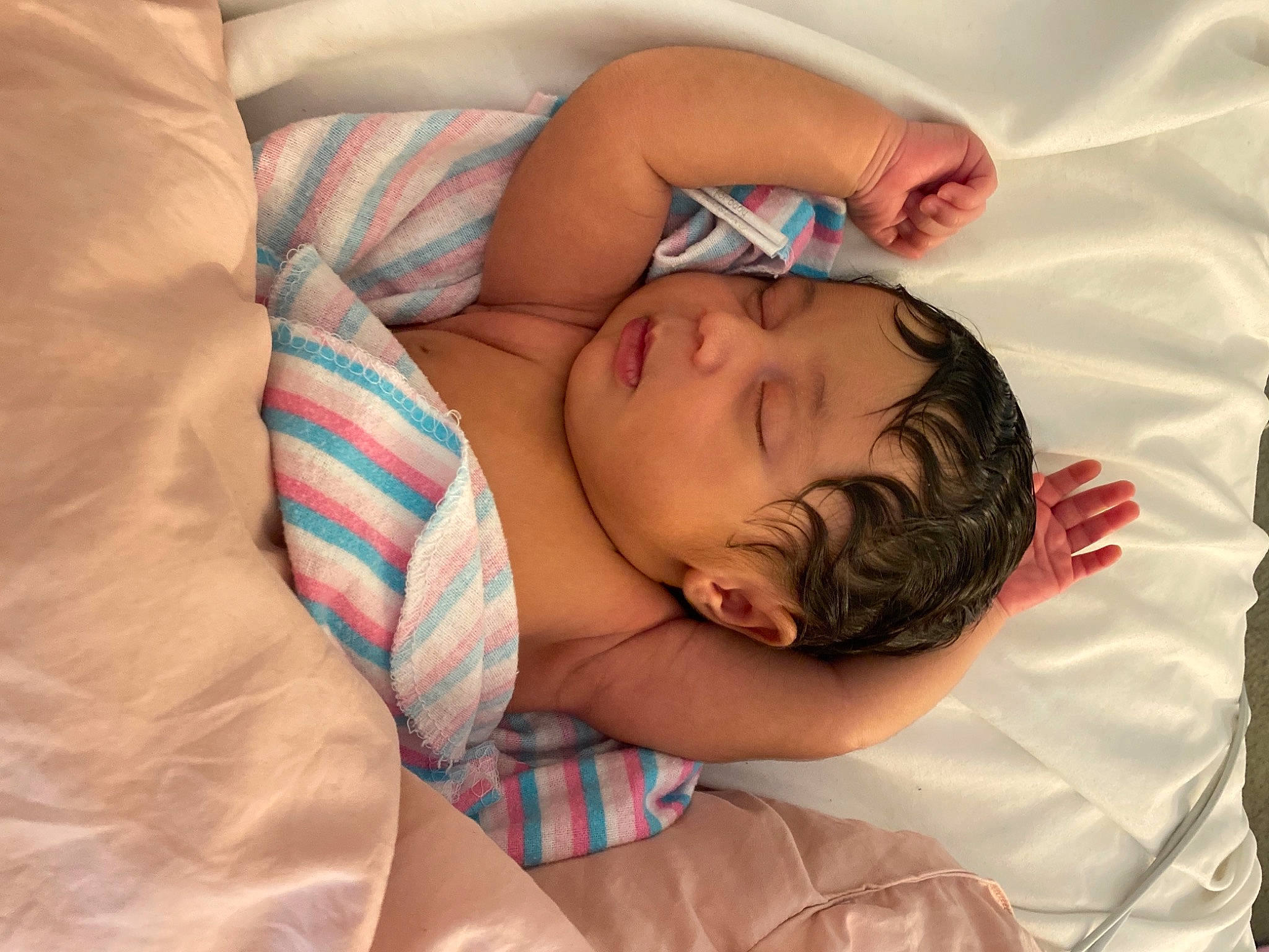 Zendaya is registered to the contest to win money with this photo: abdomen, baby_sleeping, comfort, elbow, eyelash, finger, glasses, hair, hand, head, human_body, joint, linens, mammal, mouth, neck, person, shoulder, skin, textile