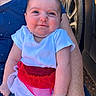 baby, child, infant, smile, face, arm, clothing, red, white, blue, person, outdoor, tire, vehicle, cute, happy, skin, portrait, sitting, holding