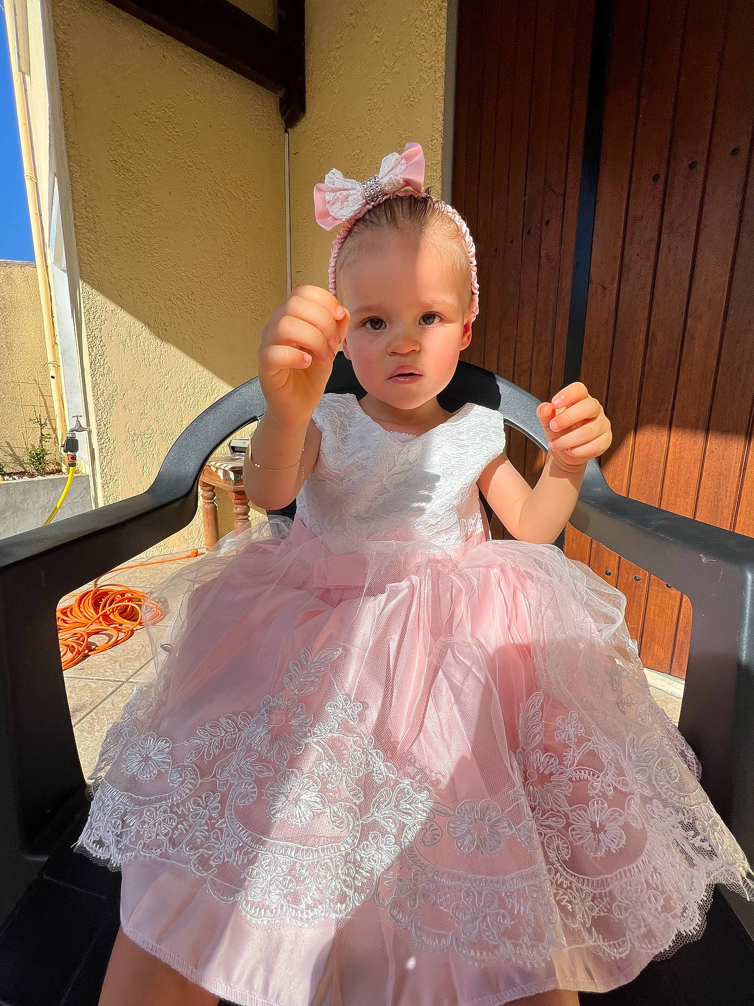 Kamélia participe au concours pour gagner de l'argent avec cette photo : baby, baby_toddler_clothing, bridal_accessory, day_dress, dress, embellishment, facial_expression, fashion, fashion_design, fun, gown, happy, headpiece, iris, person, pink, shoulder, skin, sleeve, toddler