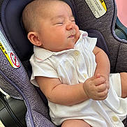 Willow joined the competition — help win amazing prizes! baby, infant, car_seat, white_clothing, earring, scrunched_face, cute, child, seat_belt_warning, purple_car_seat, expressive_face, small_hands, indoors, newborn, adorable, comfortable, casual_clothing, human, portrait, resting