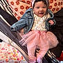 Amaia joined the competition — help win amazing prizes! baby, child, smiling, pink, tutu, headband, denim_jacket, onesie, bed, pillow, floral_pattern, striped_bedding, sock, cute, infant, happy, portrait, clothing, toddler, indoor