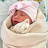 newborn, baby, infant, sleeping, pink_hat, swaddled, blanket, floral_bedding, portrait, face, closed_eyes, peaceful, cozy, indoors, textile, soft_lighting, headwear, infant_clothing, nursery, photography