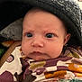 Maylin joined the competition — help win amazing prizes! baby, infant, face, eyes, blanket, patterned_clothing, hood, closeup, skin, expression, curious, child, young, portrait, indoors, person, cuteness, warm, soft, newborn