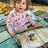 art_supplies, barefoot, blanket, blue_eyes, carpet, child, coloring_book, creative, curly_hair, floor, home, indoor, paintbrush, person, playtime, sitting, starfish, sweater, toddler, water_glass