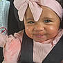 Ava joined the competition — help win amazing prizes! baby, car_seat, child, closeup, curly_hair, cute, face, happy, headband, indoor, infant, person, pink_bow, pink_clothing, plush_toy, portrait, safety_belt, seatbelt, smile, soft_toy