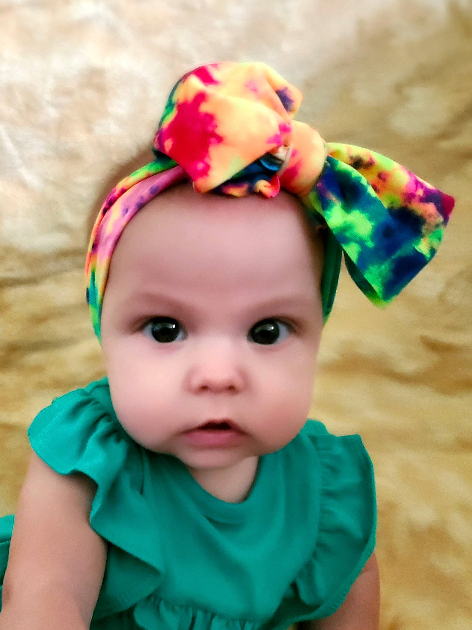 Norah is registered to the contest to win money with this photo: baby, baby_toddler_clothing, cap, child, clothing, costume_accessory, ear, fashion_accessory, hair_accessory, hat, head, headband, headgear, headwear, pattern, person, pink, toddler, turquoise