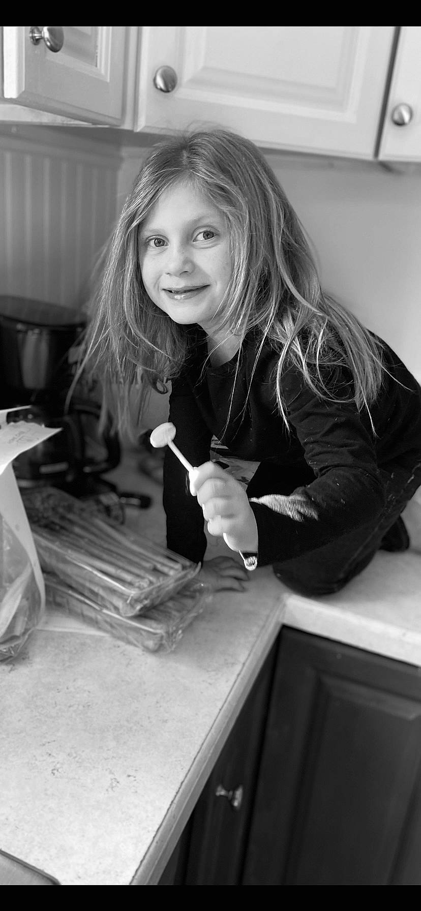 Mara joined the competition — help win amazing prizes! black, black_and_white, blond, child, curious, facial_expression, fun, hair, happy, joy, monochrome, monochrome_photography, person, room, sitting, smile, snapshot, stock_photography, style, table