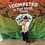 Levi is registered to the contest to win money with this photo: child, martial_arts, karate, medal, belt, pose, smile, headband, trophy, championship, background, banner, concrete_floor, sportswear, young_athlete, indoor, competition, victory, celebration, toddler