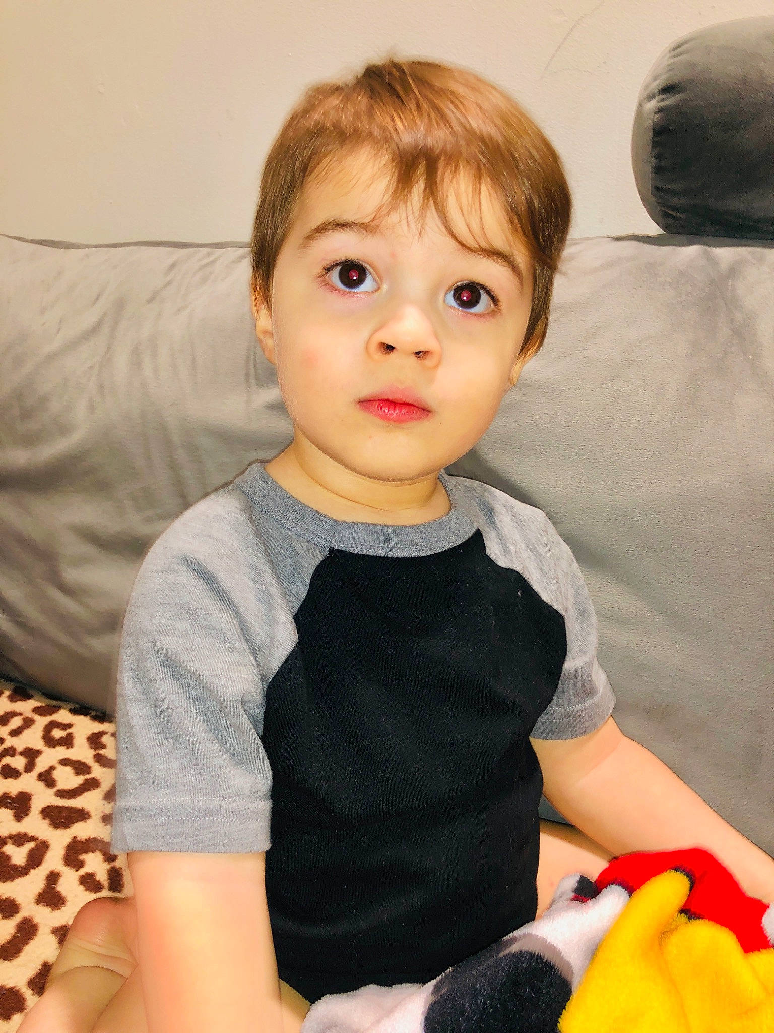 Nathan is registered to the contest to win money with this photo: arm, baby, baby_toddler_clothing, cheek, child, comfort, couch, elbow, eyelash, fun, happy, iris, nose, pattern, person, room, sitting, skin, sleeve, surprise