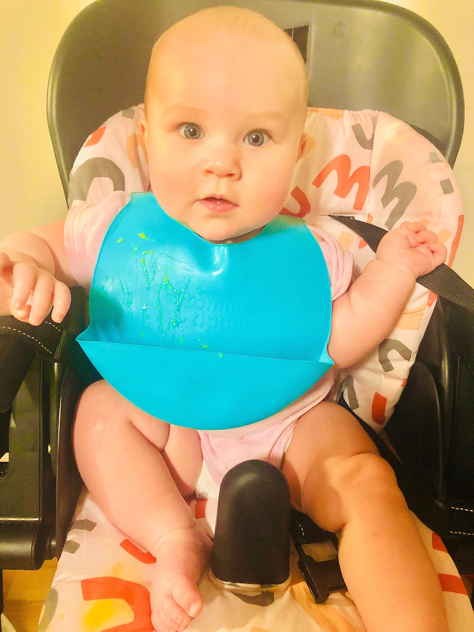 Madison is registered to the contest to win money with this photo: arm, baby, baby_products, baby_toddler_clothing, chair, cheek, child, comfort, finger, happy, human_body, human_leg, knee, mouth, person, sitting, skin, sleeve, thigh, thumb