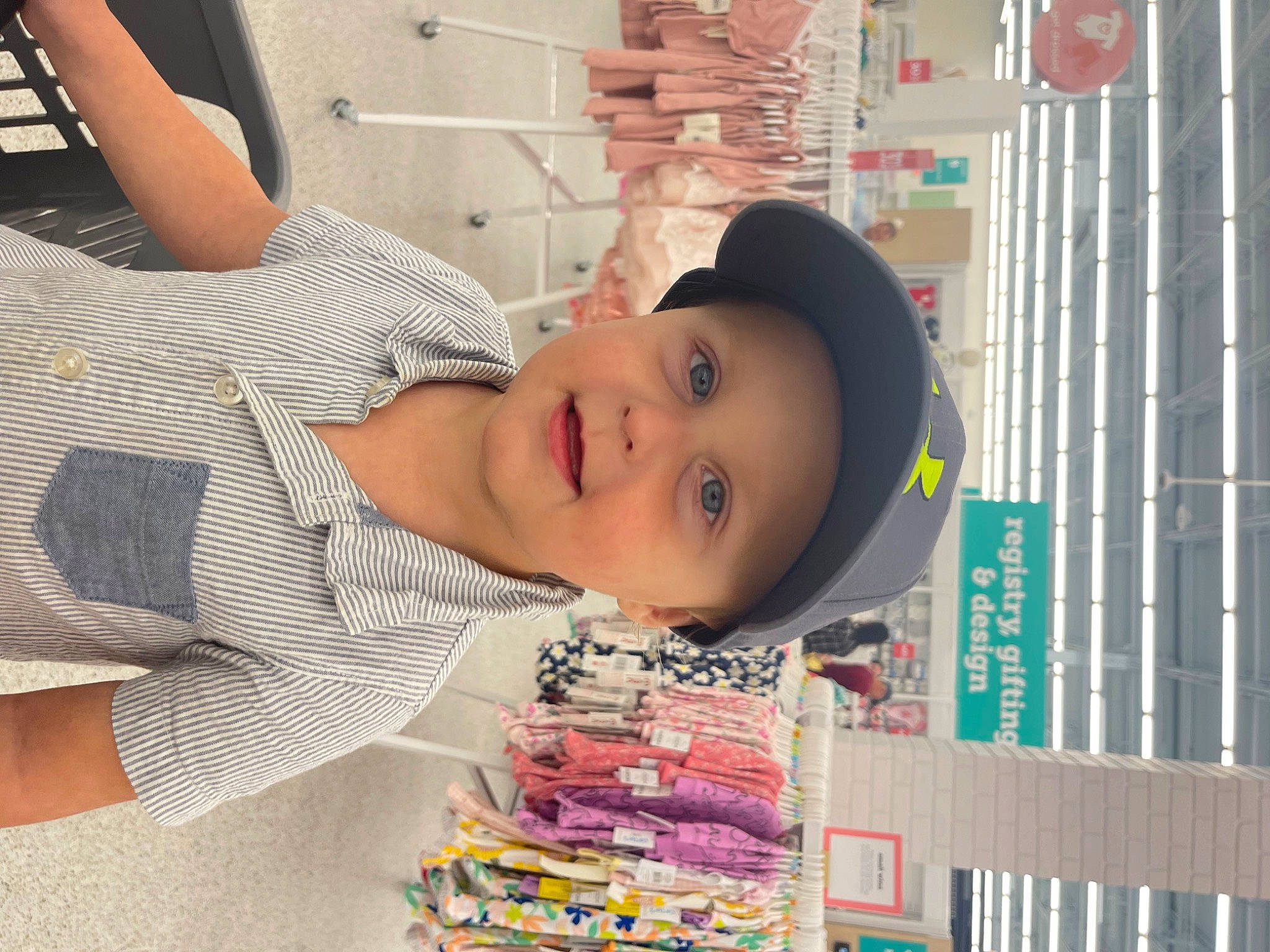 Houston is registered to the contest to win money with this photo: baby, beauty, building, child, fun, happy, hat, headwear, pattern, person, product, publication, retail, room, shelving, smile, t_shirt, textile, toddler
