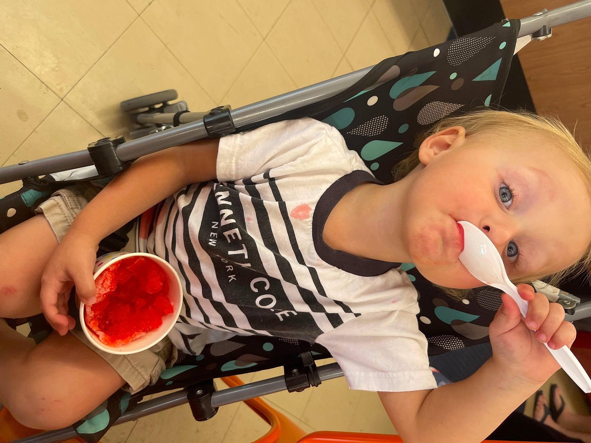 Houston is registered to the contest to win money with this photo: baby, chest, elbow, food, human_body, human_leg, ingredient, kitchen_utensil, music, orange, person, produce, recipe, recreation, shorts, sportswear, tableware, thigh, toddler, tomato