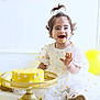 toddler, child, birthday, cake, yellow, dress, smiling, happy, balloons, celebration, face_paint, flower, party, golden_cake_stand, white_background, floor, sitting, cute, playful, fun