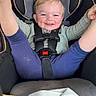 toddler, child, car_seat, grinning, happy, smiling, sweater, pants, car_interior, blanket, seatbelt, safety_harness, blue, green, clothing, infant, cute, playful, portrait, baby