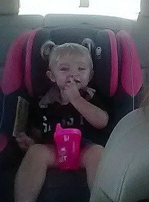 Jackie is registered to the contest to win money with this photo: auto_part, baby, baby_in_car_seat, car_seat, child, mouth, person, pink, seat_belt, toddler