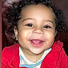 baby, casual, child, clothing, curly_hair, cute, drool, expression, face, happy, indoor, leather_background, person, portrait, red_jacket, sitting, smile, teeth, toddler, young_child