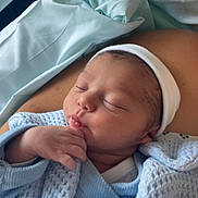 Kayden participe au concours pour gagner de l'argent avec cette photo : newborn, baby, sleeping, blanket, blue, hand, face, headwear, indoors, closeup, infant, peaceful, resting, portrait, soft, warm, cozy, skin, human, child