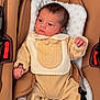 baby, infant, car_seat, clothing, soft_fabric, newborn, padded, seatbelt, child, portrait, indoors, cute, small_hands, sleepwear, resting, young, face, person, comfortable, blanket