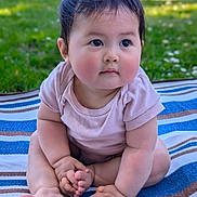 Tessa is registered to the contest to win money with this photo: baby, child, infant, outdoor, grass, blanket, striped_blanket, cute, chubby, sitting, pink_shirt, hands, feet, portrait, young_child, skin, face, eyes, curious, nature