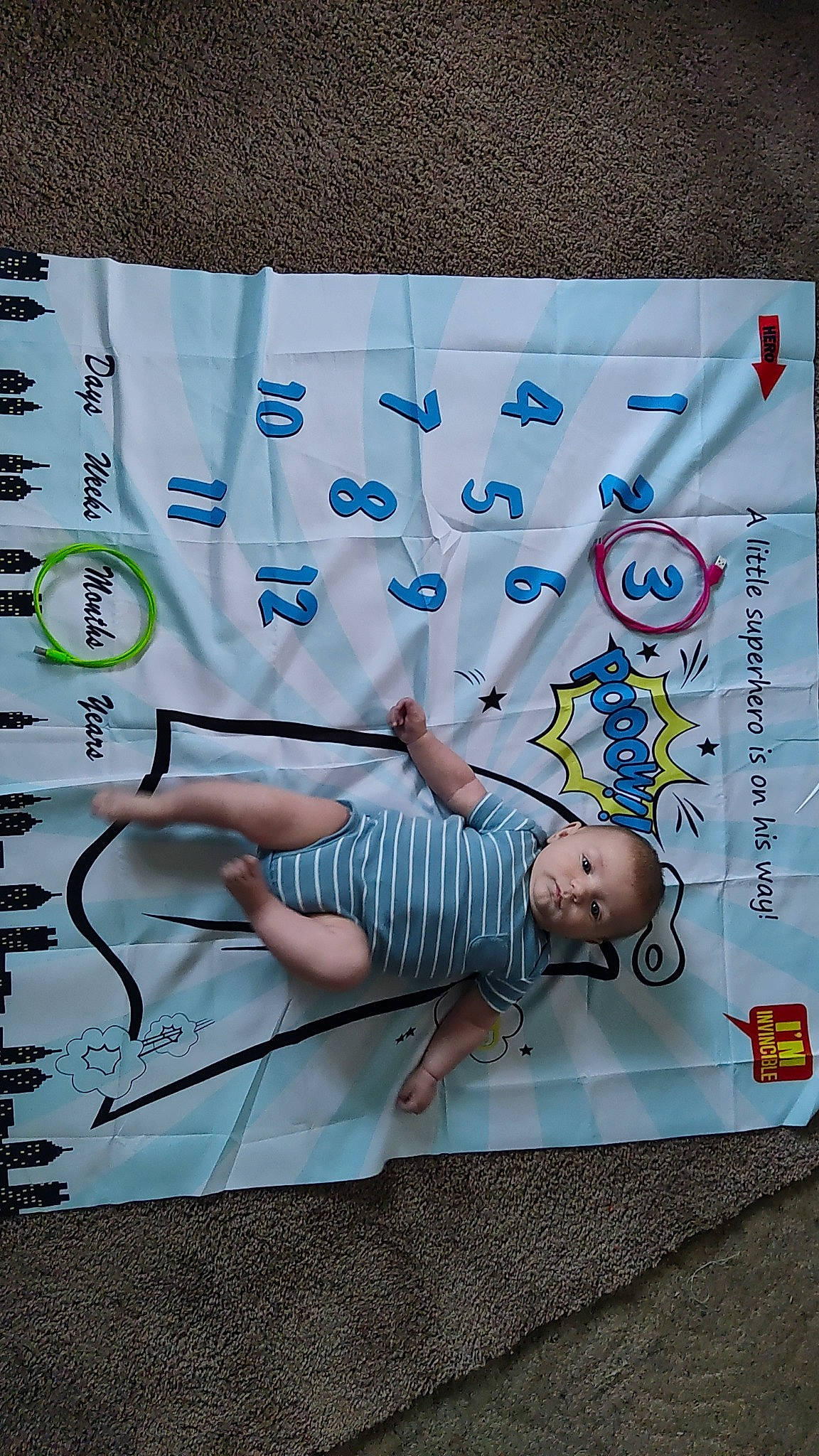 Gavin is registered to the contest to win money with this photo: advertising, art, baby, child, flooring, font, fun, graphics, grass, happy, leisure, linens, paper, pattern, person, room, t_shirt, textile, visual_arts