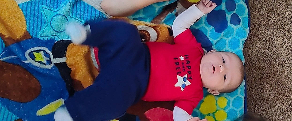 Gavin joined the competition — help win amazing prizes! arm, blue, child, elbow, electric_blue, event, fun, gesture, hand, happy, human_body, joint, lap, leisure, person, room, stuffed_toy, textile, thigh, toddler