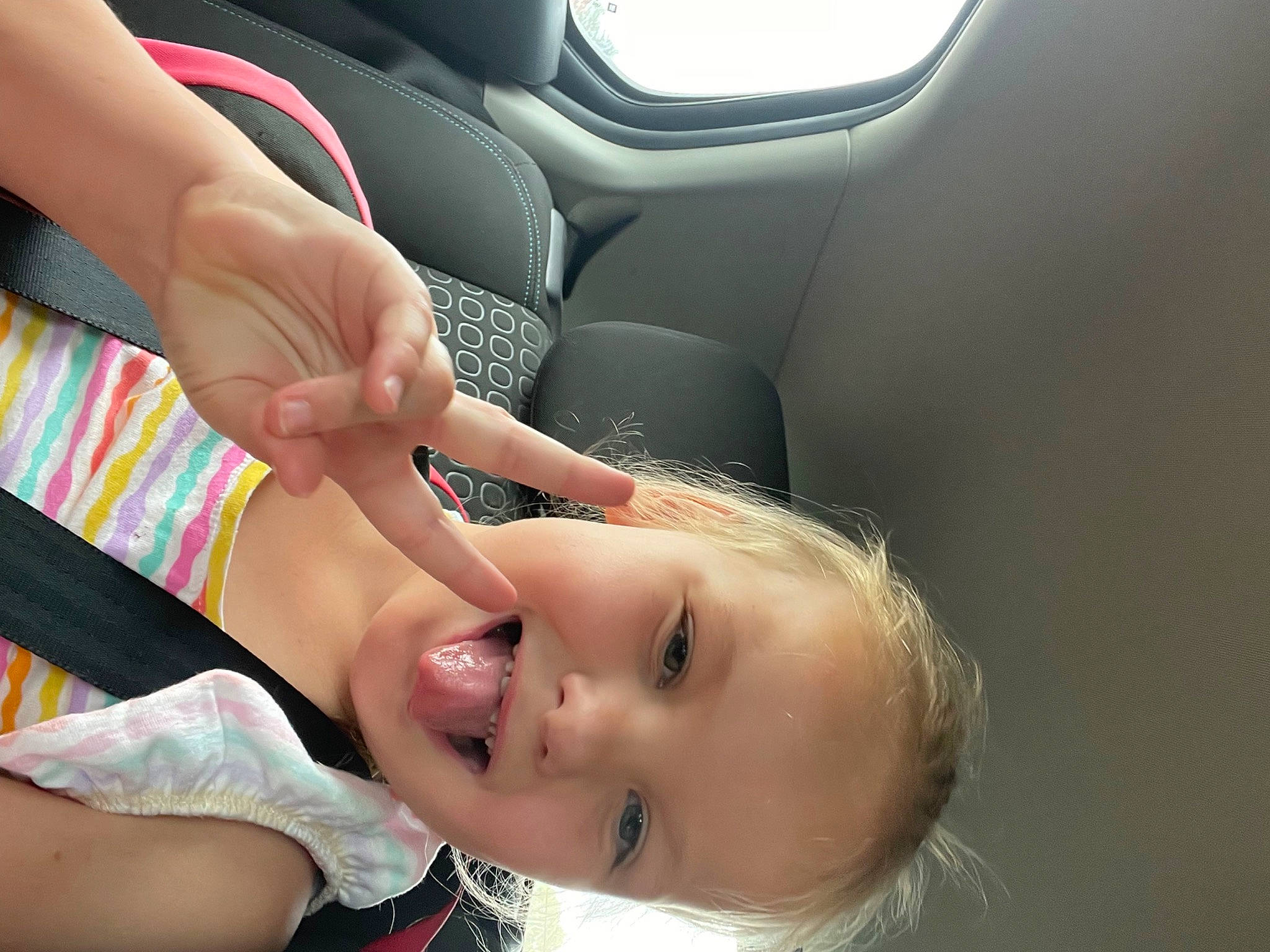 Maddi is registered to the contest to win money with this photo: auto_part, car_seat, chest, child, eyelash, eyewear, face, family_car, finger, fun, gesture, happy, joy, leisure, nail, person, skin, smile, thumb, toddler