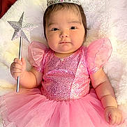 Madelyn joined the competition — help win amazing prizes! baby, child, crown, magic_wand, pink_dress, fairy_tale, sparkles, tulle_skirt, cute, portrait, indoor, soft_blanket, happy, smiling, young_child, infant, costume, celebration, dress_up, adorable