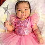 baby, child, crown, magic_wand, pink_dress, fairy_tale, sparkles, tulle_skirt, cute, portrait, indoor, soft_blanket, happy, smiling, young_child, infant, costume, celebration, dress_up, adorable