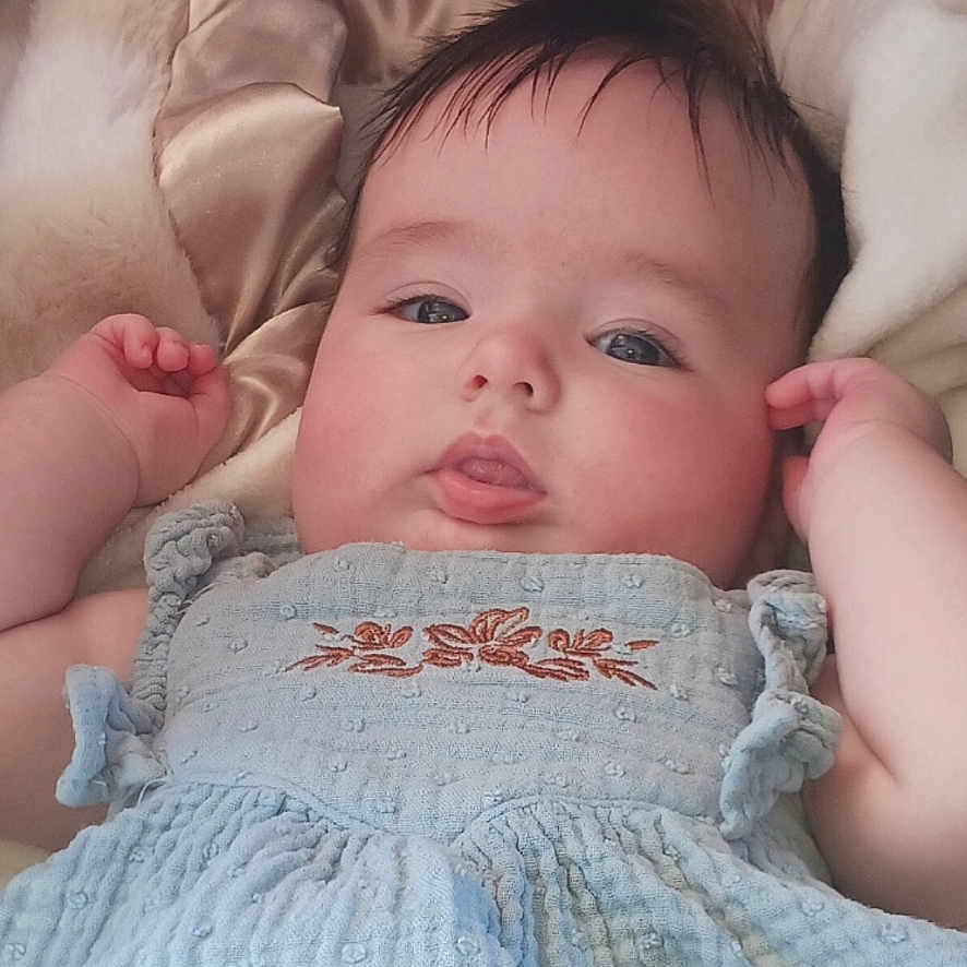 Nova Nyx joined the competition — help win amazing prizes! arms, baby, blanket, blue_dress, calm, child, closeup, cute, expression, face, fur, indoors, infant, lying_down, person, portrait, satin, skin, soft_texture, young
