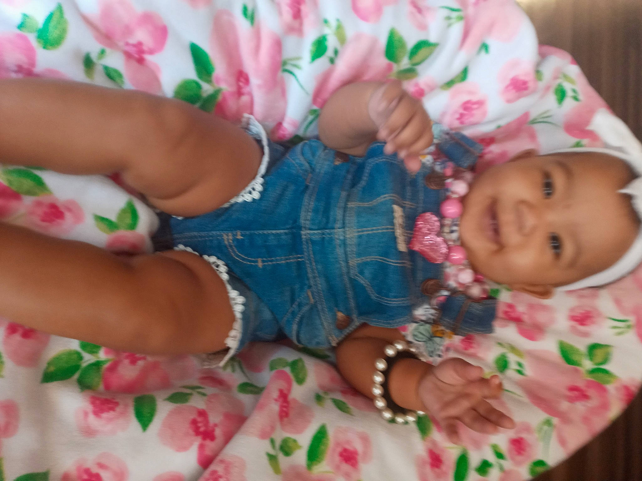 Journee is registered to the contest to win money with this photo: baby, baby_products, baby_toddler_clothing, cheek, child, dress, face, finger, hand, happy, linens, nail, pattern, person, pink, product, skin, sleeve, smile, textile