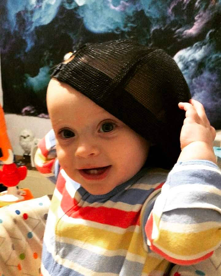 Arthur is registered to the contest to win money with this photo: baby, baby_toddler_clothing, cap, carmine, cheek, child, christmas, costume_hat, event, fashion_accessory, fun, gesture, happy, headgear, headwear, holiday, people_in_nature, person, smile, toddler