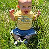 Wylder joined the competition — help win amazing prizes! baby, child, grass, outdoor, smiling, yellow_tshirt, denim_shorts, happy, nature, sunlight, sitting, greenery, cute, person, young_child, summer, playful, feet, socks, portrait