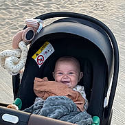 Alix participe au concours pour gagner de l'argent avec cette photo : baby, baby_toy, blanket, carseat, child, comfort, cute, fabric, happy, infant, leisure, outdoor, person, plaything, sand, seat, smiling, stroller, toy, wood