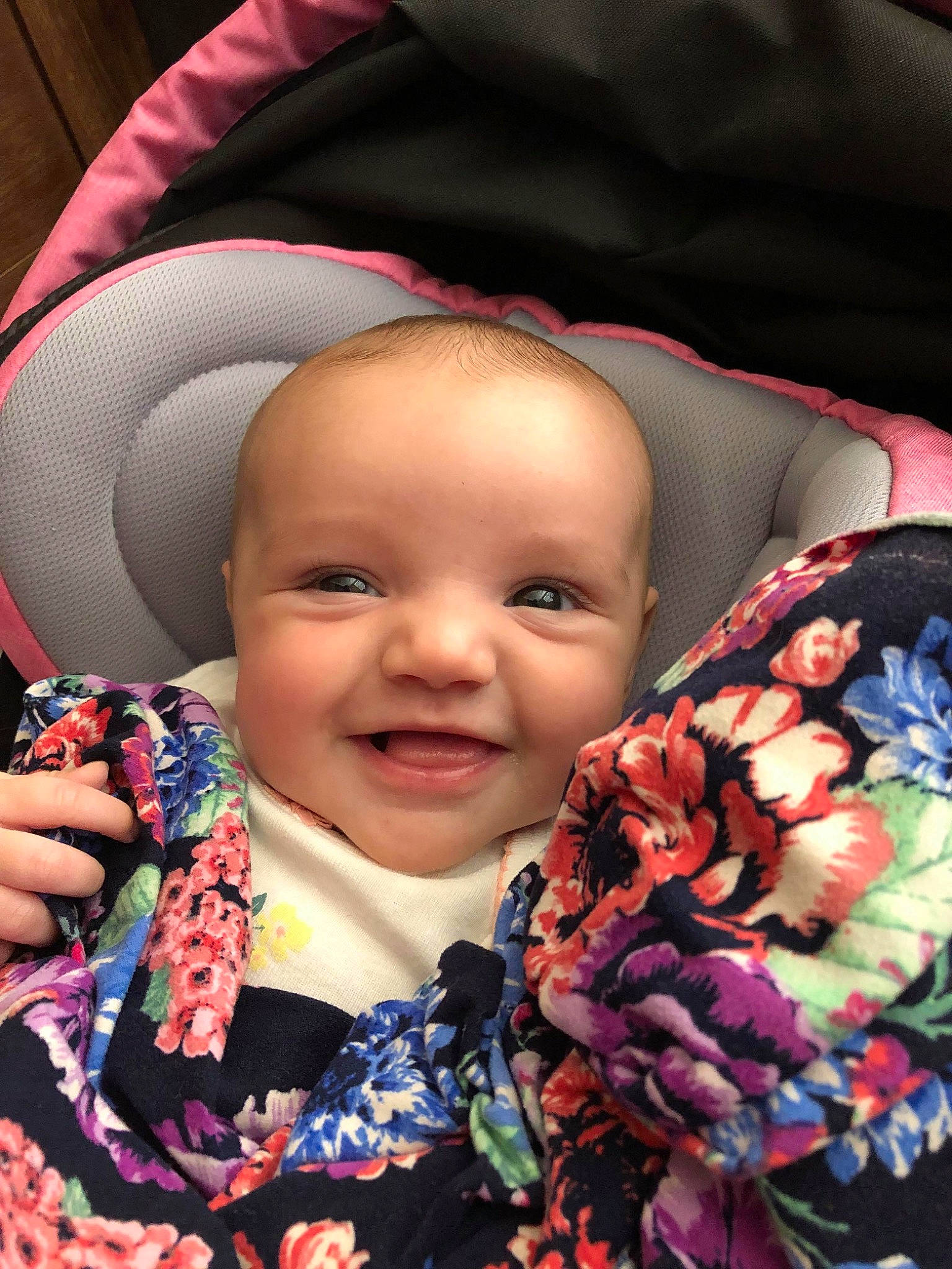 Rylie is registered to the contest to win money with this photo: baby, baby_carriage, baby_products, car_seat, cheek, child, eye, face, head, iris, joy, lip, person, pink, product, scarf, skin, smile, textile, toddler