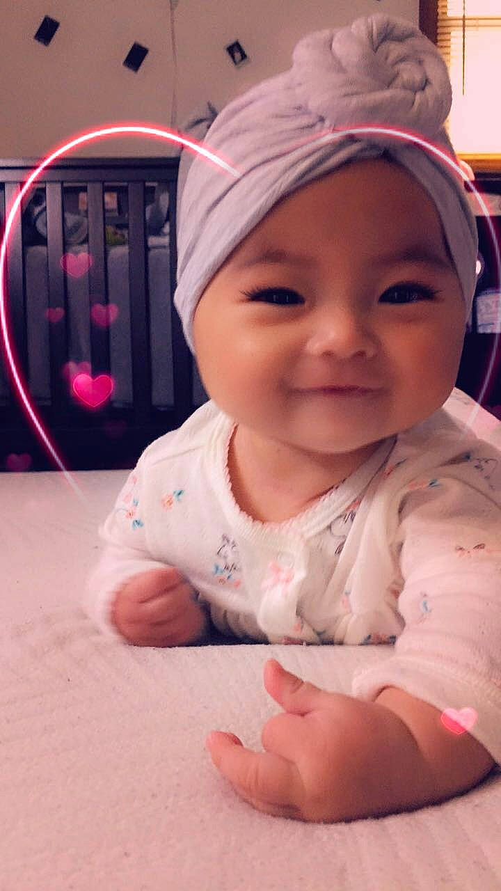 Dezire is registered to the contest to win money with this photo: baby, cheek, child, face, facial_expression, forehead, hair_accessory, head, headgear, joy, lip, mouth, nose, person, pink, skin, smile, toddler