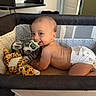 baby, child, cute, diaper, furniture, happy, head, indoor, infant, leopard_toy, mesh, pacifier, person, playpen, plush_toy, room, skin, smile, toy, zebra_toy