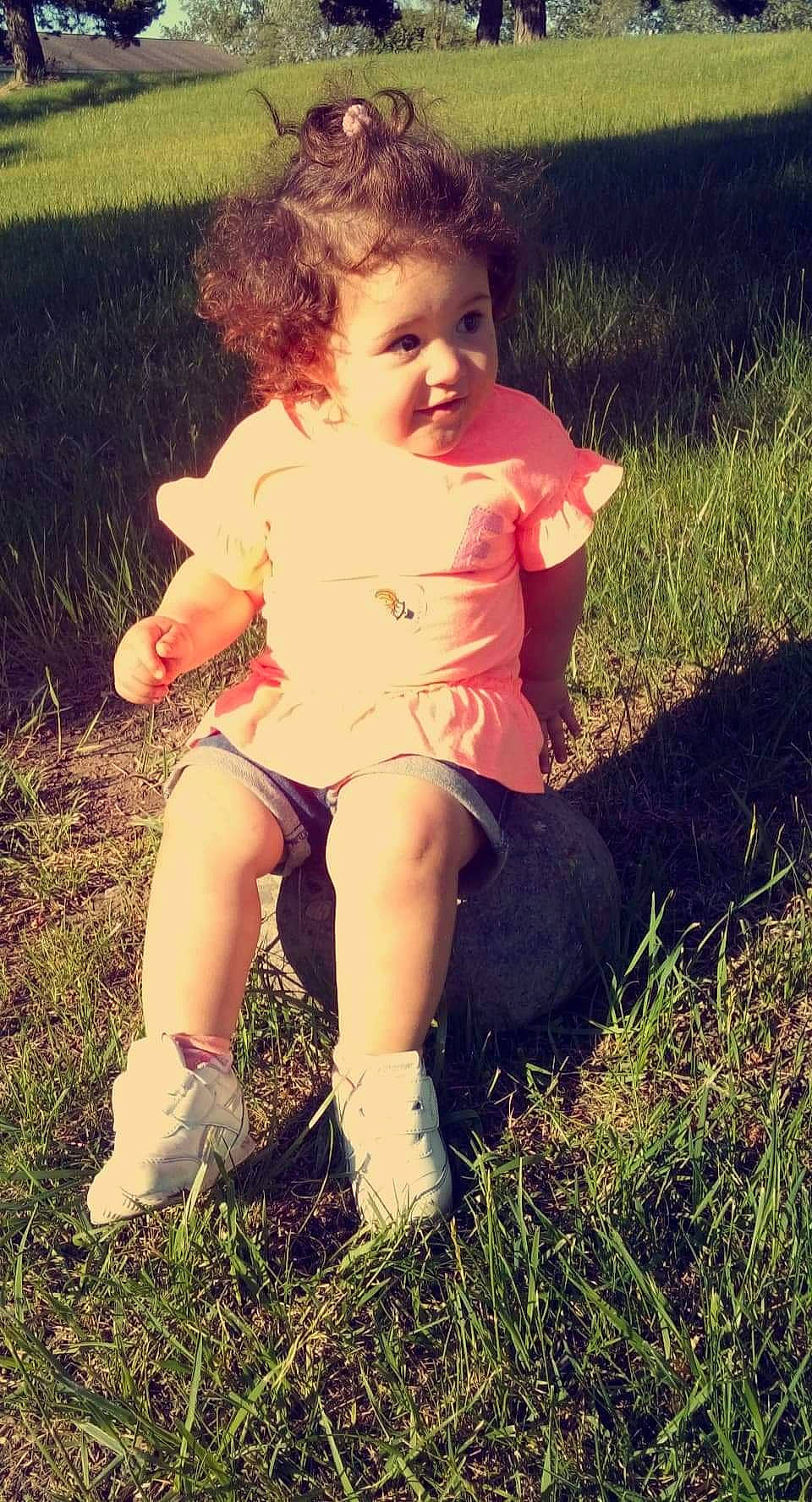 Sophia is registered to the contest to win money with this photo: cool, dress, face, finger, flash_photography, grass, grassland, hand, happy, human_body, leg, meadow, people_in_nature, person, plant, shorts, skin, smile, summer, sunlight