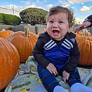 Jayden is registered to the contest to win money with this photo: adidas, autumn, blanket, child, cloud, crying, curly_hair, expression, fall, fence, garden, hedge, jeans, nature, outdoor, pumpkin, sad, sky, socks, toddler