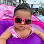 Amanda is registered to the contest to win money with this photo: baby, sunglasses, pool, floatie, water, summer, child, pink, purple, outdoor, swimwear, fun, cute, person, infant, toy, relaxation, vacation, sun_protection, leisure